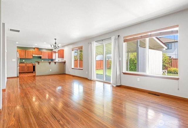 167 Wind River Rd, Chehalis, WA 98532 - unfurnished living room with a chandelier, baseboards, light wood-style flooring, and recessed lighting
