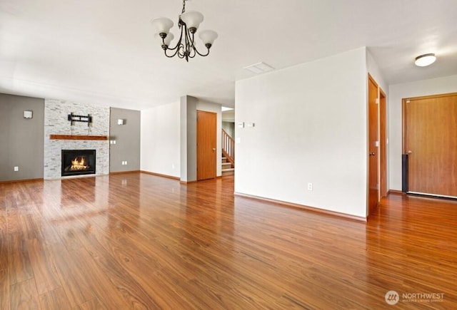 167 Wind River Rd, Chehalis, WA 98532 - unfurnished living room with a chandelier, wood finished floors, stairway, and a fireplace