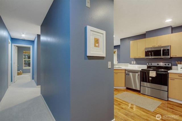 20802 72nd Ave W Unit 304, Edmonds, WA 98026 - kitchen with appliances with stainless steel finishes, light countertops, light wood-type flooring, baseboards, and a sink