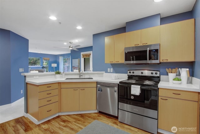 20802 72nd Ave W Unit 304, Edmonds, WA 98026 - kitchen featuring stainless steel appliances, a peninsula, a sink, light brown cabinets, and recessed lighting