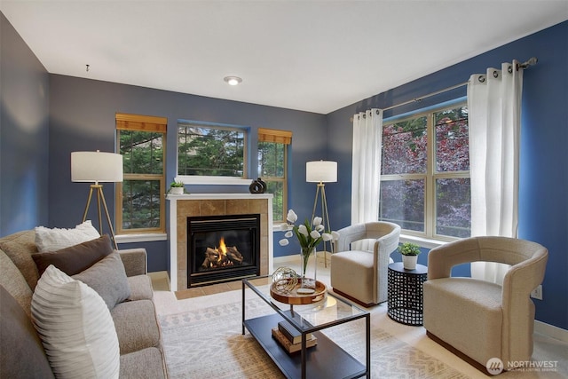 20802 72nd Ave W Unit 304, Edmonds, WA 98026 - living room with healthy amount of natural light, a tile fireplace, and baseboards