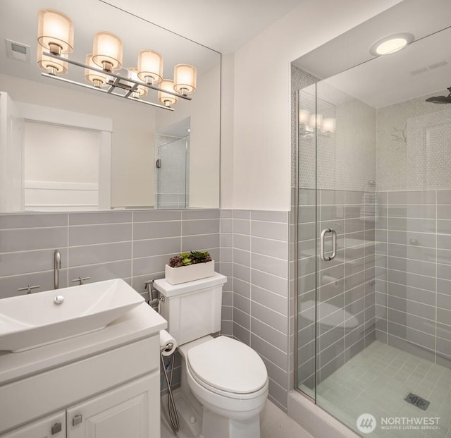 11862 155th Ave NE, Redmond, WA 98052 - bathroom featuring tile walls, a shower stall, toilet, and vanity
