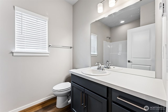 41 E Compass Ln, Allyn, WA 98524 - bathroom with wood finished floors, a shower, toilet, vanity, and baseboards