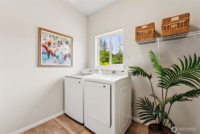 41 E Compass Ln, Allyn, WA 98524 - clothes washing area featuring washing machine and clothes dryer, baseboards, and light wood-style flooring