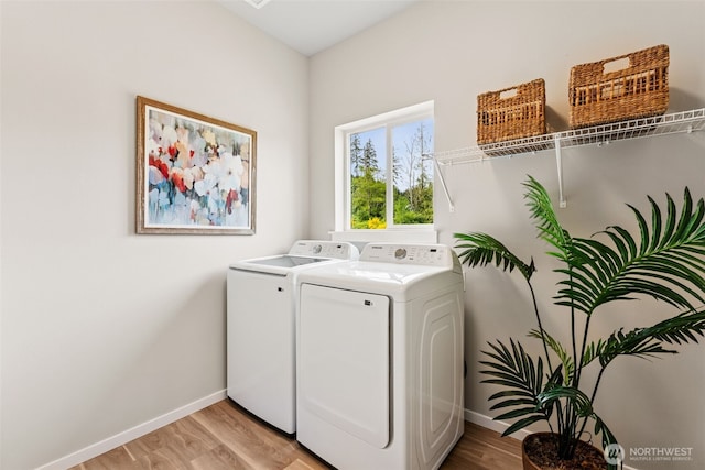41 E Compass Ln, Allyn, WA 98524 - clothes washing area featuring washing machine and clothes dryer, baseboards, and light wood-style flooring
