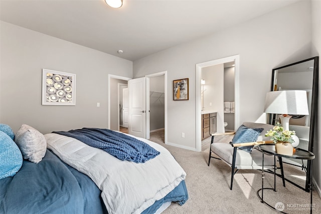 41 E Compass Ln, Allyn, WA 98524 - bedroom with light colored carpet, a walk in closet, baseboards, connected bathroom, and a closet