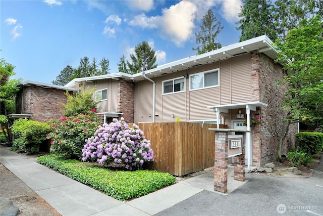 12211 SE 59th St Unit 61, Bellevue, WA 98006 - view of front of house with fence and brick siding