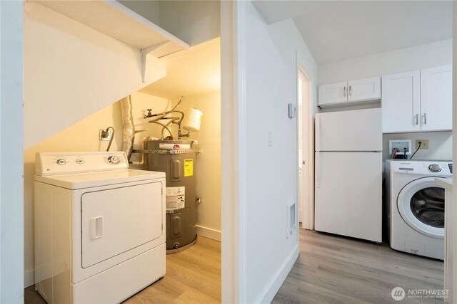 12211 SE 59th St Unit 61, Bellevue, WA 98006 - clothes washing area with electric water heater, light wood finished floors, independent washer and dryer, and baseboards