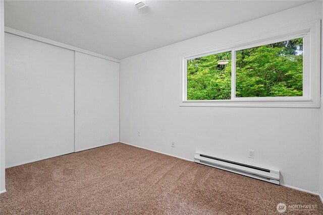 12211 SE 59th St Unit 61, Bellevue, WA 98006 - spare room with baseboard heating, carpet floors, and baseboards