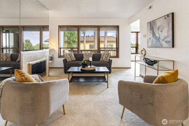 living room with healthy amount of natural light, carpet floors, and baseboards