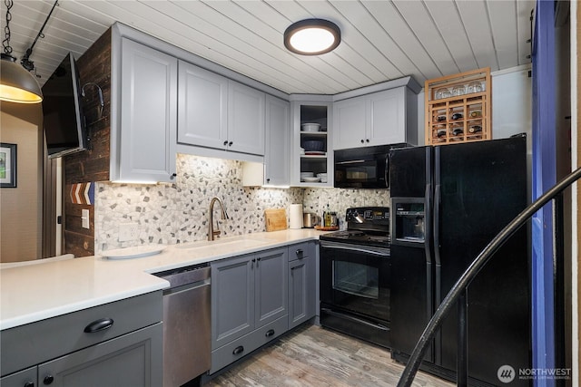735 E Promontory Rd, Shelton, WA 98584 - kitchen featuring black appliances, gray cabinetry, a sink, wood ceiling, and light countertops