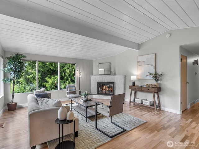 8711 Bowdoin Way, Edmonds, WA 98026 - living area featuring vaulted ceiling, a fireplace, baseboards, wood finished floors, and wooden ceiling