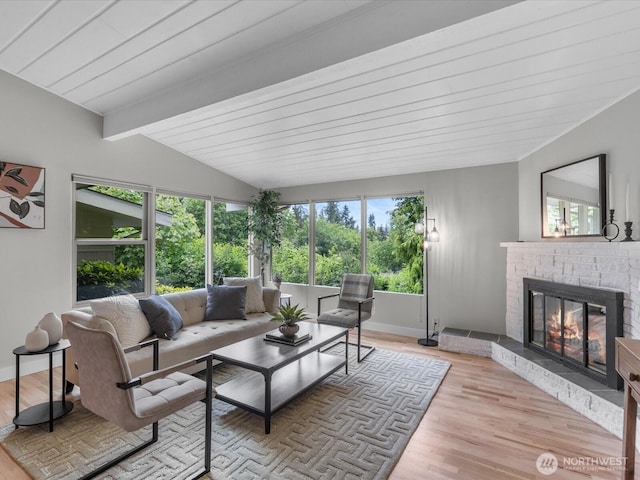 8711 Bowdoin Way, Edmonds, WA 98026 - living room featuring a brick fireplace, light wood-style flooring, and baseboards