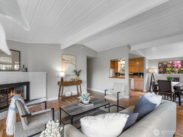 8711 Bowdoin Way, Edmonds, WA 98026 - living room featuring light wood-type flooring, baseboards, and a glass covered fireplace