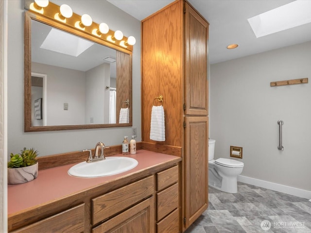 8711 Bowdoin Way, Edmonds, WA 98026 - full bathroom with a skylight, toilet, vanity, and baseboards