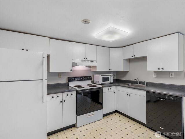 8711 Bowdoin Way, Edmonds, WA 98026 - kitchen with white appliances, a sink, under cabinet range hood, dark countertops, and white cabinetry