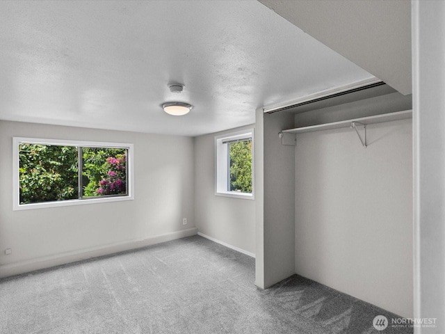 8711 Bowdoin Way, Edmonds, WA 98026 - unfurnished bedroom with carpet, a textured ceiling, a closet, and baseboards