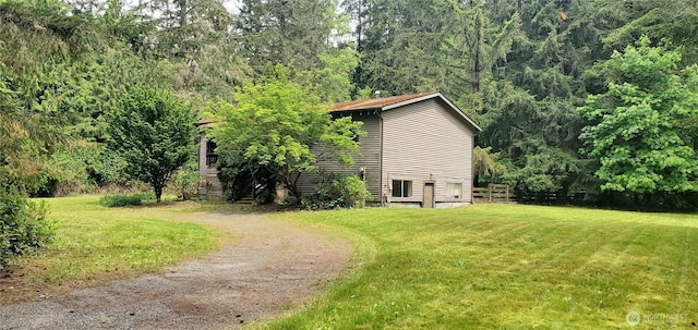 22930 115th Ave SW, Vashon, WA 98070 - view of home's exterior featuring a lawn and a wooded view