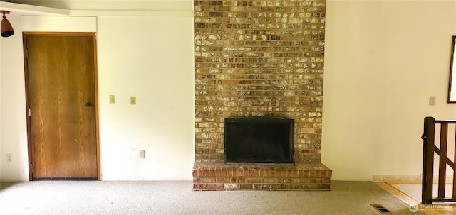 22930 115th Ave SW, Vashon, WA 98070 - unfurnished living room featuring a brick fireplace and carpet floors