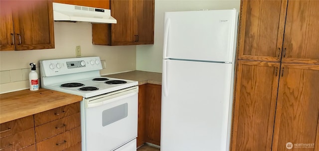 22930 115th Ave SW, Vashon, WA 98070 - kitchen featuring white appliances, under cabinet range hood, and brown cabinets