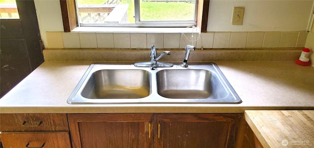 22930 115th Ave SW, Vashon, WA 98070 - kitchen view of a sink, decorative backsplash, light countertops, and brown cabinetry