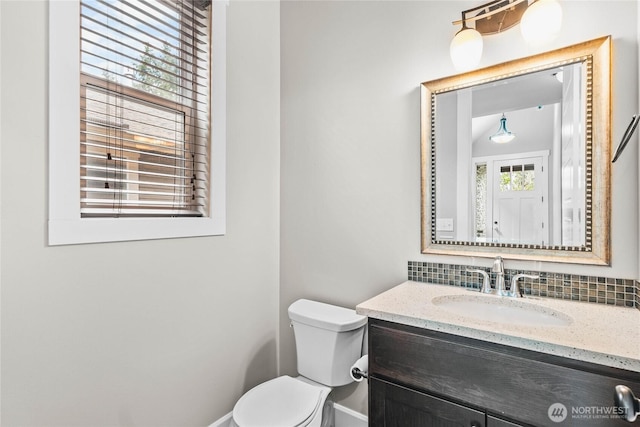 6410 83rd Avenue Ct W, University Place, WA 98467 - bathroom featuring toilet, vanity, tasteful backsplash, and baseboards