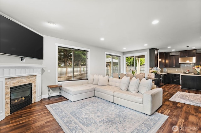 6410 83rd Avenue Ct W, University Place, WA 98467 - living area with dark wood-style floors, recessed lighting, a stone fireplace, and baseboards