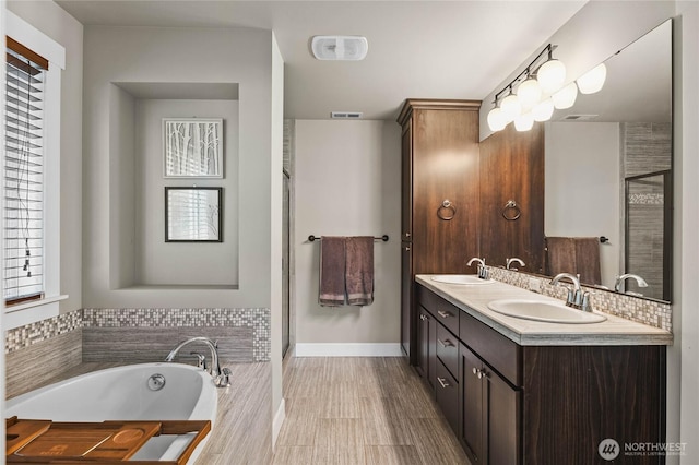 6410 83rd Avenue Ct W, University Place, WA 98467 - bathroom featuring double vanity, a garden tub, a shower stall, and baseboards
