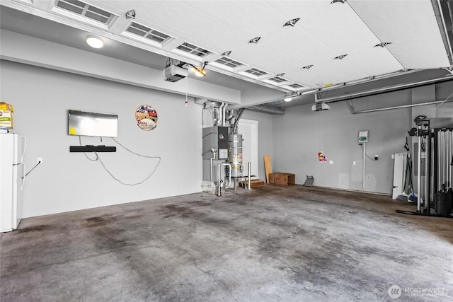 6410 83rd Avenue Ct W, University Place, WA 98467 - garage featuring freestanding refrigerator, a garage door opener, and water heater