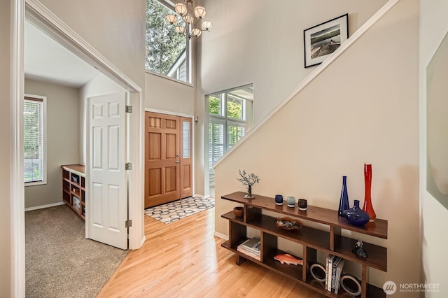 922 Chelan Ave NE, Renton, WA 98059 - foyer entrance with a chandelier, light wood-style floors, a high ceiling, and baseboards