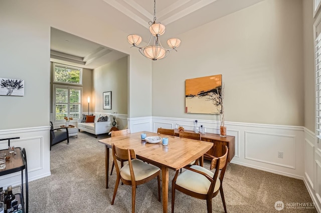 922 Chelan Ave NE, Renton, WA 98059 - dining room featuring carpet, a raised ceiling, a decorative wall, wainscoting, and a chandelier