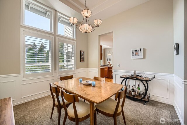 922 Chelan Ave NE, Renton, WA 98059 - dining room featuring a chandelier, carpet flooring, a decorative wall, and a wainscoted wall