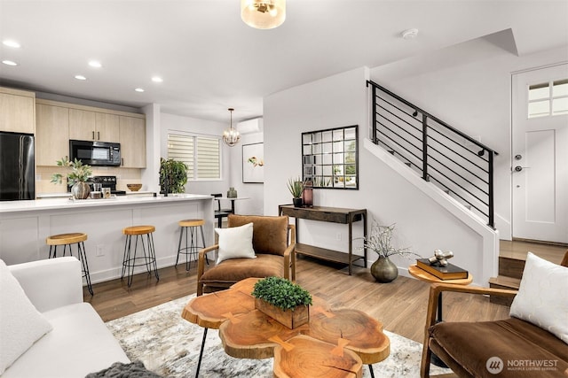 919 N 103rd St Unit A, Seattle, WA 98133 - living room featuring recessed lighting, stairway, wood finished floors, and a chandelier