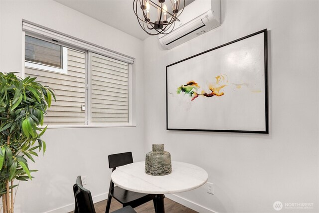 919 N 103rd St Unit A, Seattle, WA 98133 - dining room with an AC wall unit, a chandelier, baseboards, and wood finished floors
