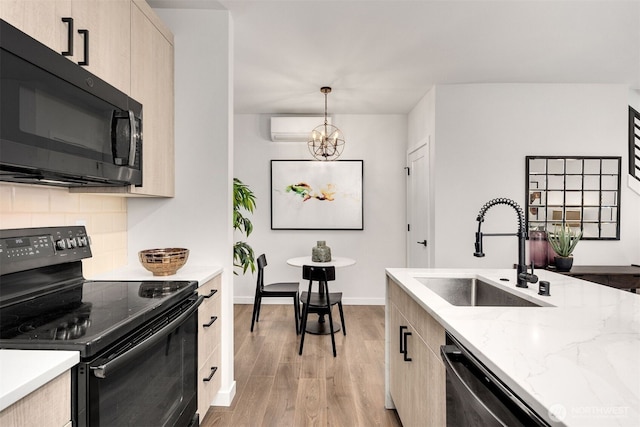 919 N 103rd St Unit A, Seattle, WA 98133 - kitchen with black appliances, a sink, light wood-type flooring, light brown cabinetry, and tasteful backsplash