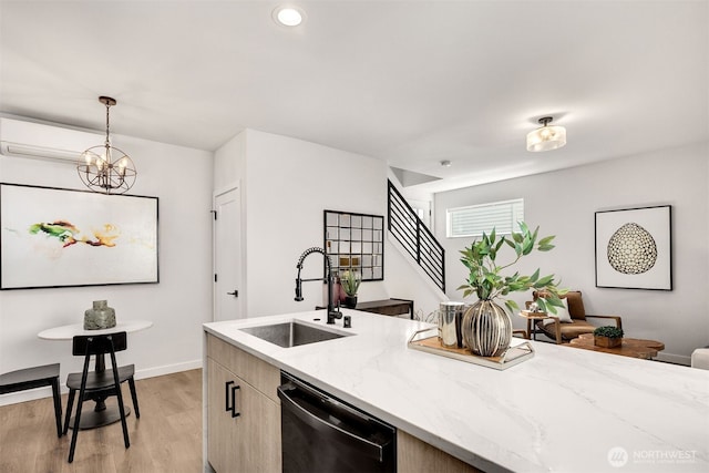 919 N 103rd St Unit A, Seattle, WA 98133 - kitchen with dishwasher, a sink, light wood-style floors, decorative light fixtures, and light stone countertops