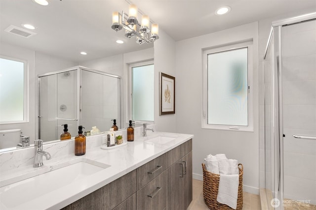 919 N 103rd St Unit A, Seattle, WA 98133 - bathroom featuring a stall shower, recessed lighting, double vanity, toilet, and baseboards
