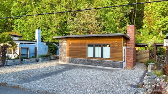 14207 Evergreen Way, Stanwood, WA 98292 - exterior space with stone siding and a chimney