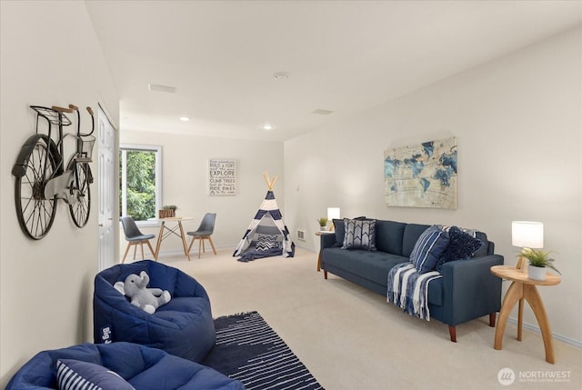 carpeted living area with baseboards and recessed lighting