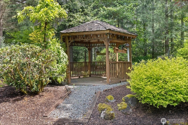 view of community featuring a gazebo and a forest view
