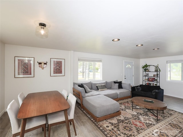 living room with wood finished floors, baseboards, and recessed lighting