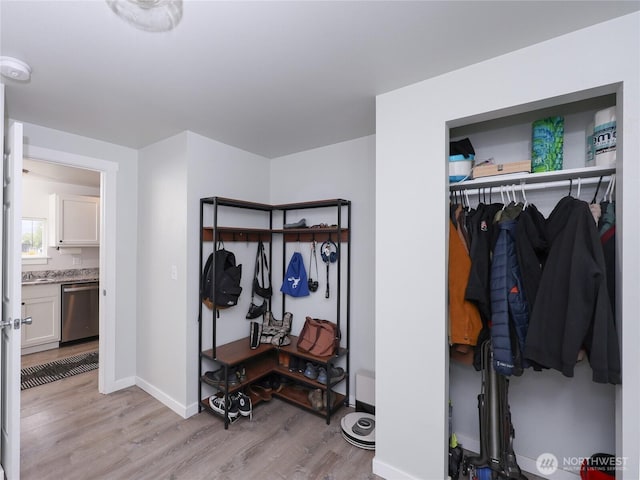 mudroom with light wood-type flooring and baseboards