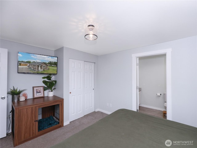 unfurnished bedroom featuring a closet, baseboards, connected bathroom, and carpet