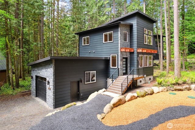 7467 Canyon View Dr, Deming, WA 98244 - contemporary house featuring asphalt driveway and stone siding