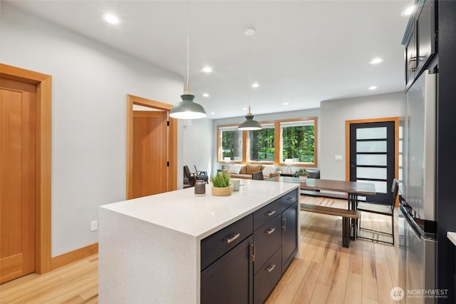 7467 Canyon View Dr, Deming, WA 98244 - kitchen featuring light wood finished floors, light countertops, a kitchen island, decorative light fixtures, and recessed lighting