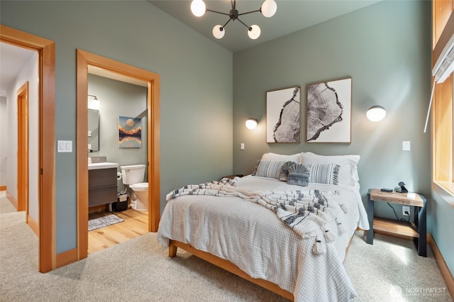 7467 Canyon View Dr, Deming, WA 98244 - bedroom featuring a chandelier, baseboards, ensuite bath, and lofted ceiling