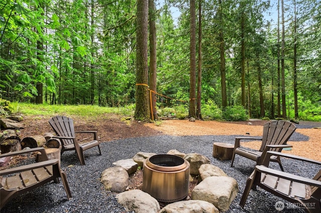 7467 Canyon View Dr, Deming, WA 98244 - view of patio / terrace with a fire pit and a forest view