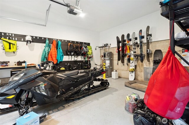 7467 Canyon View Dr, Deming, WA 98244 - garage featuring hybrid water heater, a garage door opener, and a workshop area