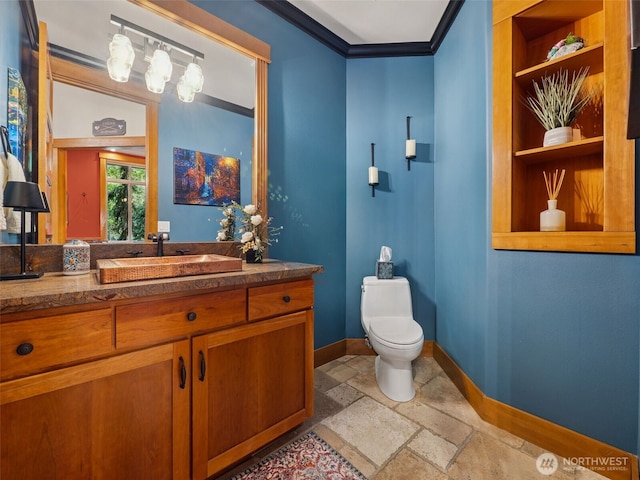28235 SE 268th St, Ravensdale, WA 98051 - half bathroom featuring baseboards, toilet, stone tile flooring, built in shelves, and ornamental molding