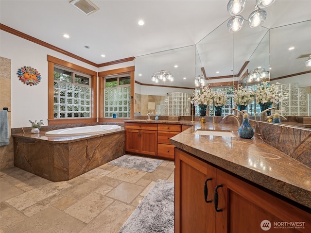 28235 SE 268th St, Ravensdale, WA 98051 - bathroom with stone tile flooring, crown molding, a garden tub, a chandelier, and recessed lighting